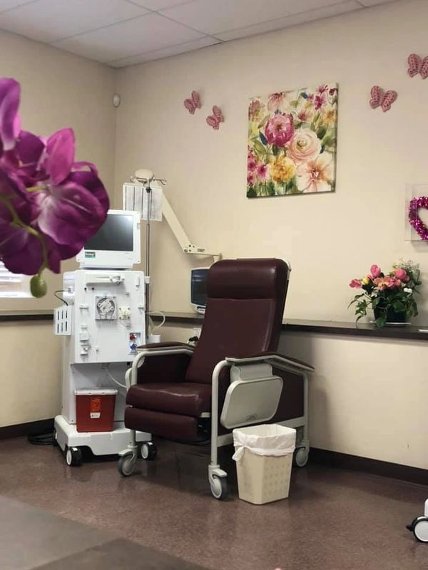 Medical treatment chair in a decorated room.