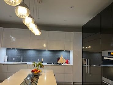 Modern Kitchen with Artistic hand painted glass insert in island