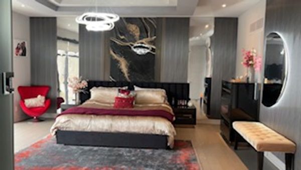 Eclectic maximalist Bedroom where color capped environment reflects a modern luxury relaxation .