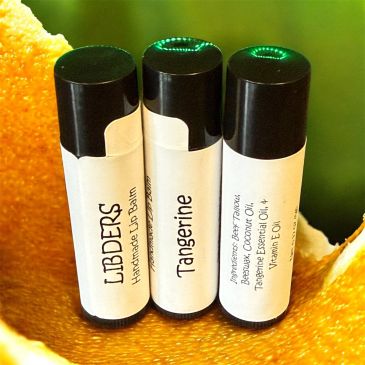 Three handmade lip balm tubes labeled LIBDERS Tangerine.