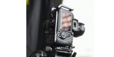 Professional DSLR camera setup on a tripod.