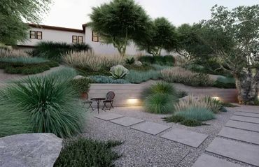 Modern garden with gravel path, lush greenery, and a small seating area.