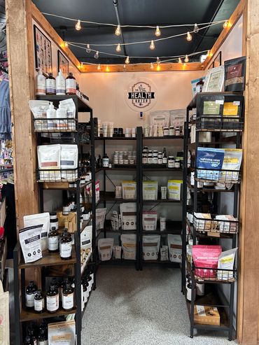 A health store corner with shelves of wellness products and string lights.