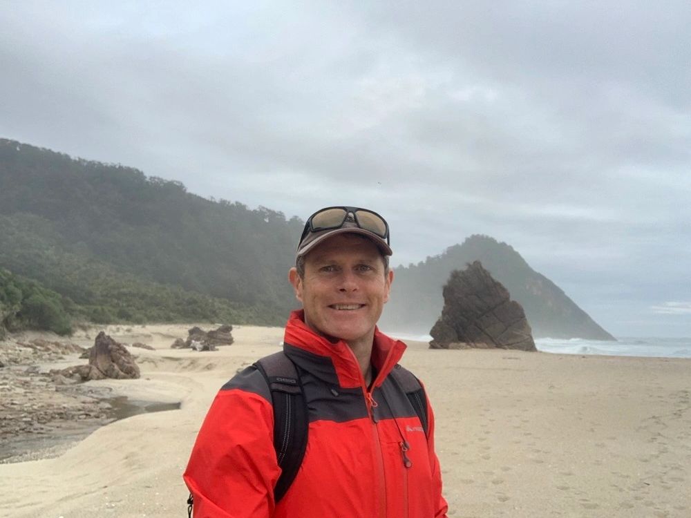 Andrew Wells from Tourism Technology Solutions on the beach on the West Coast of the South Island.