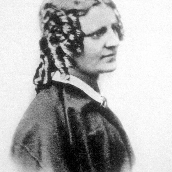 Black and white portrait of a woman with intricate hair design.