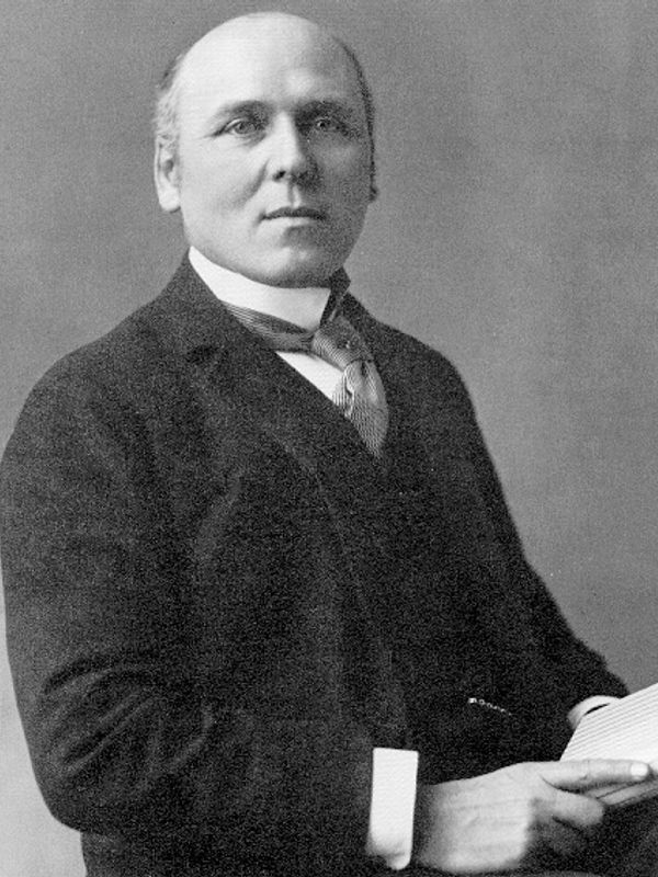 Black and white portrait of a man in formal attire.