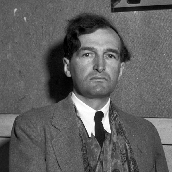 Black and white portrait of a serious man in a suit.