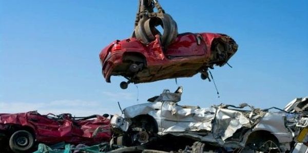 scrap cars being lifted in to the air