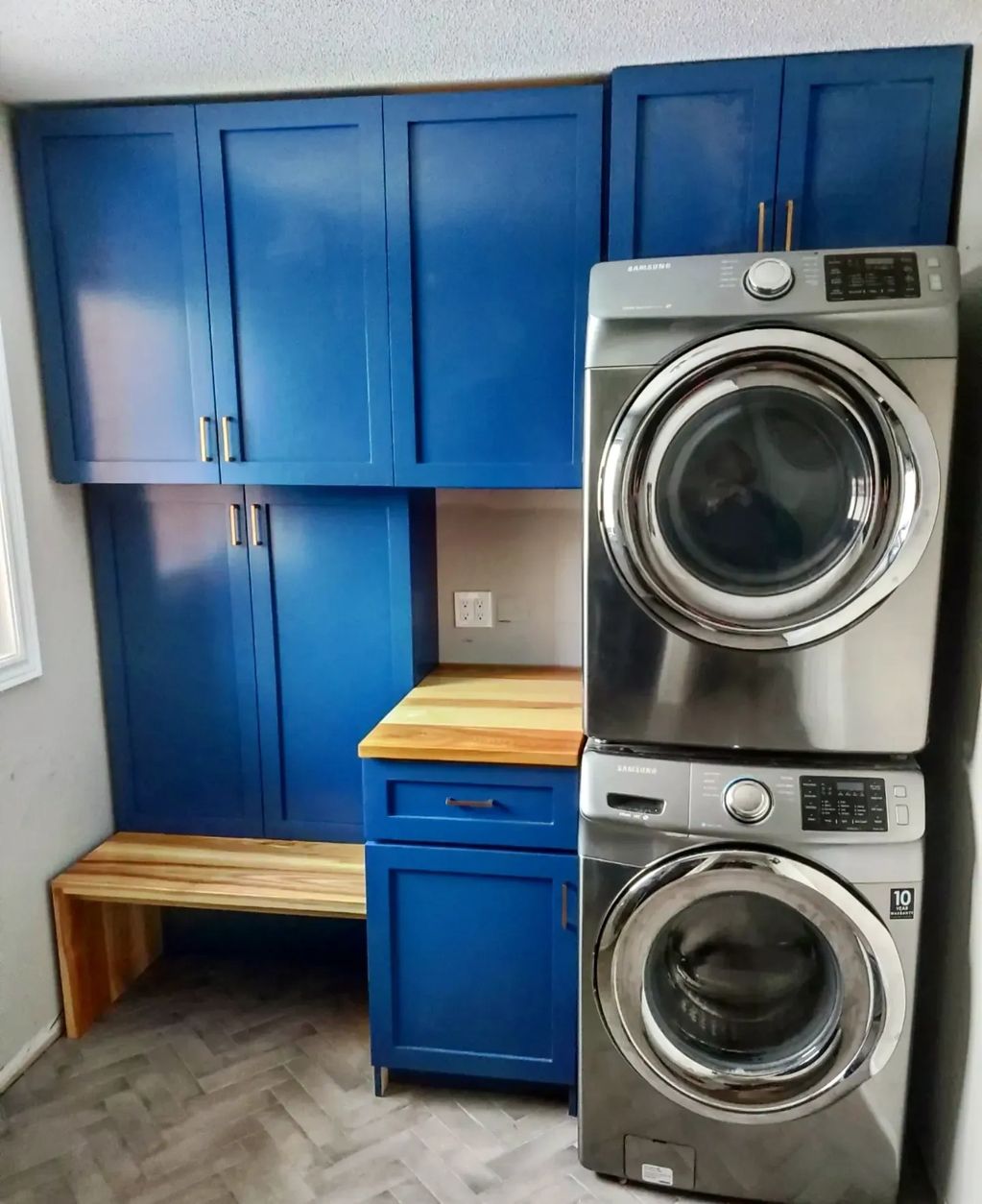 Custom mudroom with built-in cabinetry and custom Ash countertop and waterfall bench