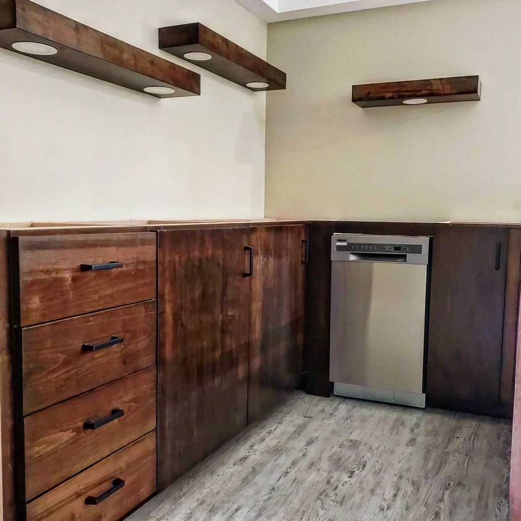 Custom kitchenette with floating shelving and integrated pot lighting
