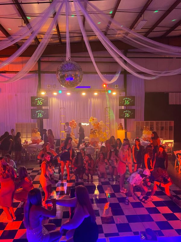 Sweet sixteen party with dancing and decorations.