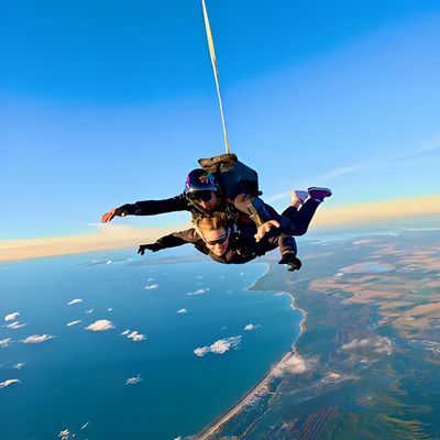 Scenic tandem skydive under canopy at sunset