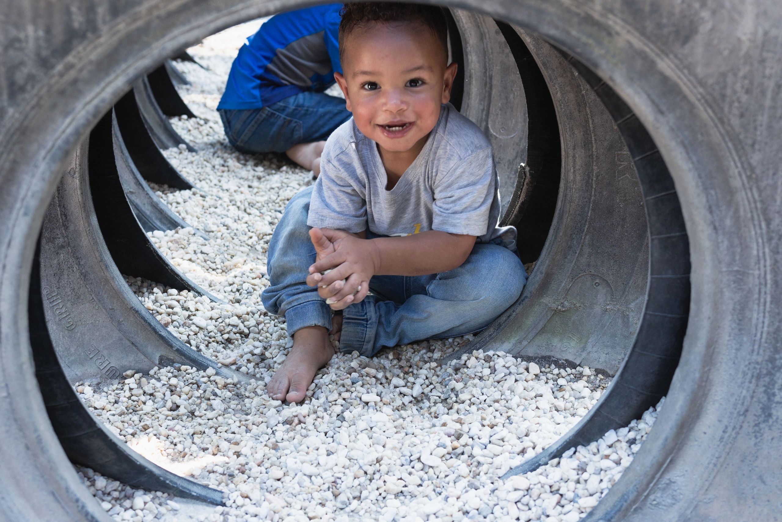 Child playing in tires. Adventure Park Lake Ridge VA.