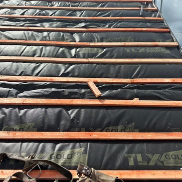 Norwich roofing company installing roof insulation by professional Norfolk roofers accredited trust