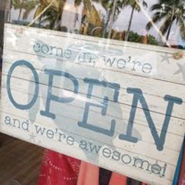 A welcoming open sign with a fun message.