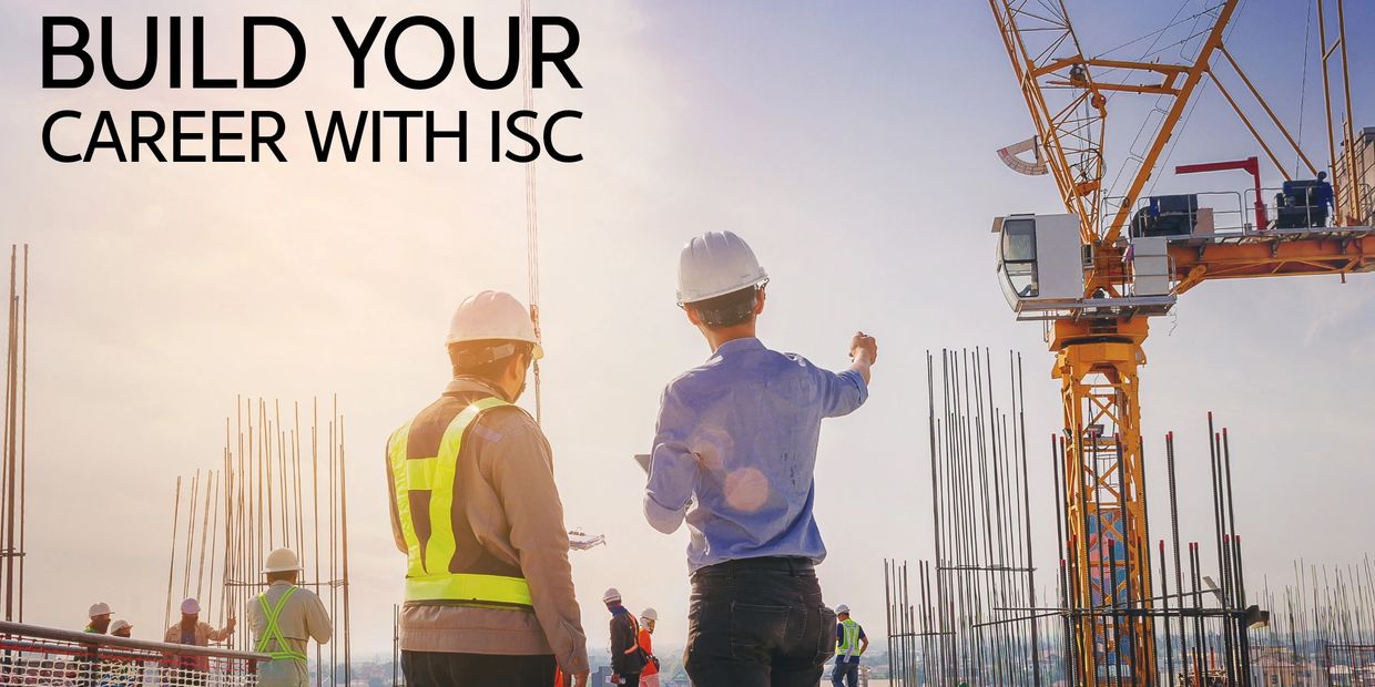 Construction workers planning a project on a building site at sunrise.