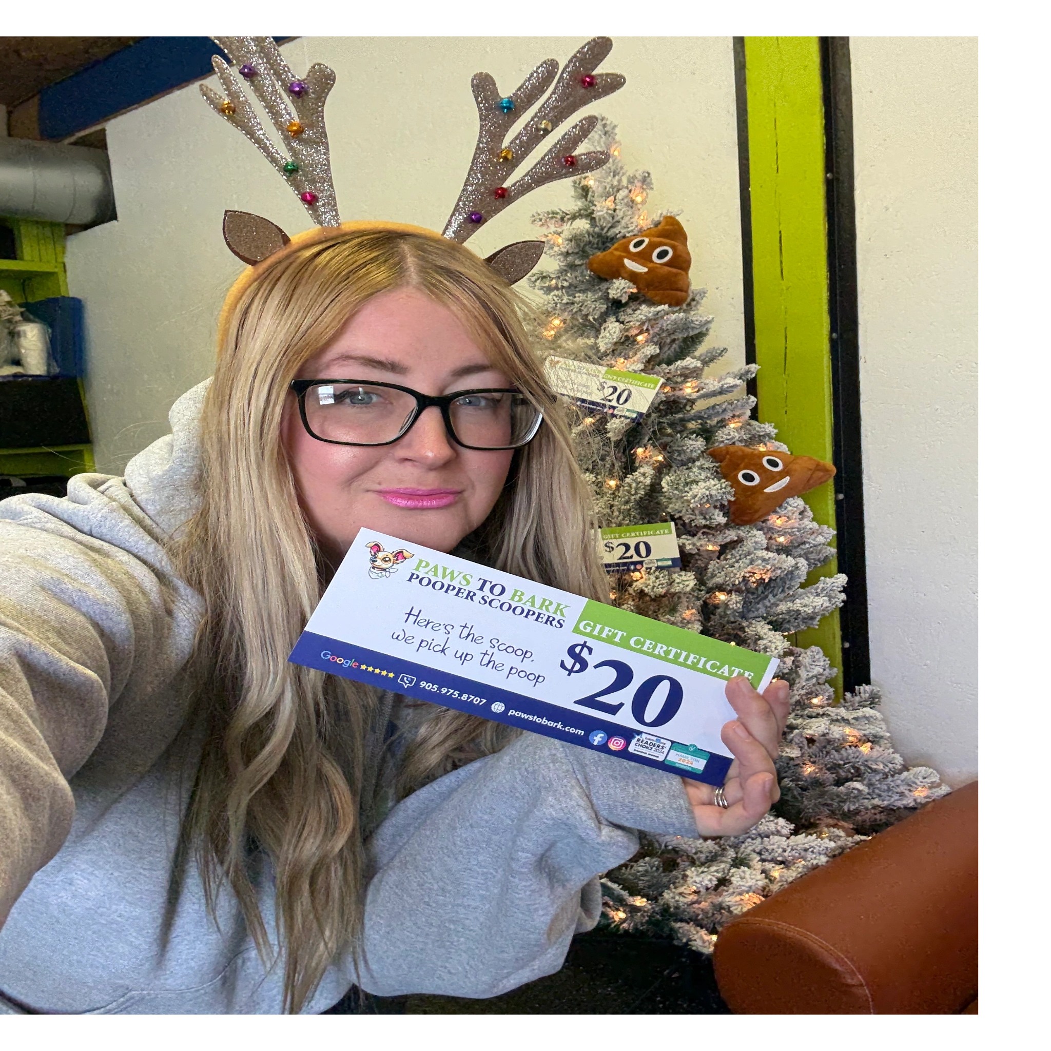 girl with blonde hair in hamilton Ontario holding dog poop scooping gift certificate for Christmas