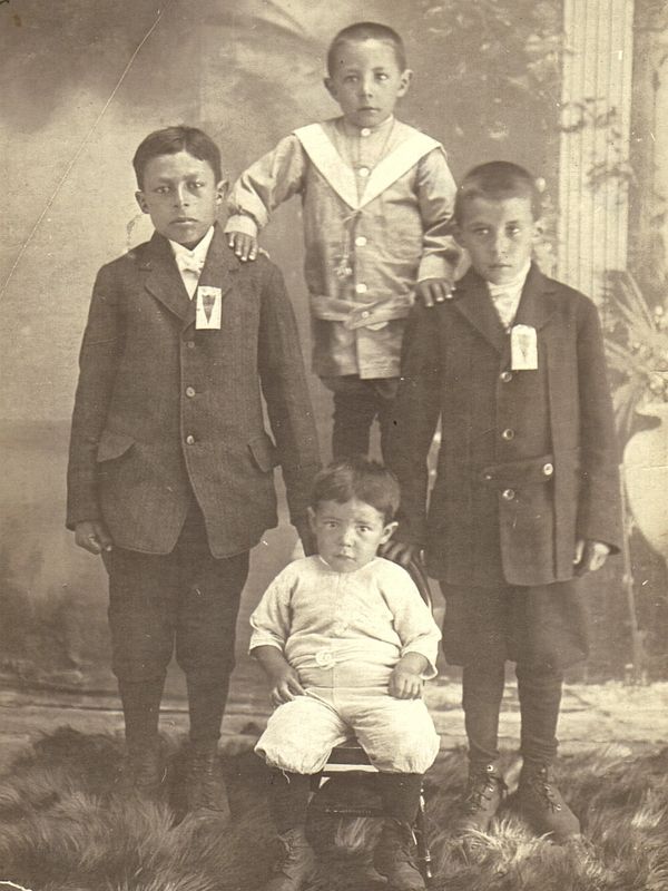 Four Metis boys at a studio portrait.