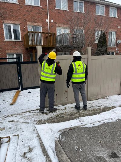 EXA Takaful Canada crew installing a new privacy fence at a condominium townhouse complex in the GTA