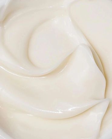 Close-up of smooth, creamy white lotion texture.