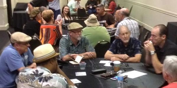 People sitting around round tables getting lessons.