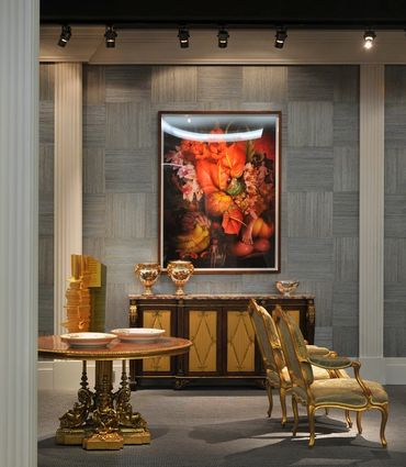 Room with classical art pieces, rich colors, and opulent furniture