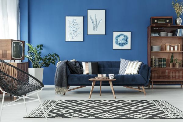 Stylish living room with a bold blue wall, mid-century modern furniture