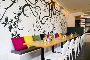 Vibrant office space with wall art and colorful seating