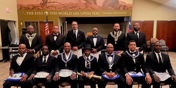 Group of men in formal Masonic attire posing indoors.