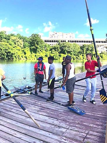 Youth standing near Cuyahoga River for athletic rowing.