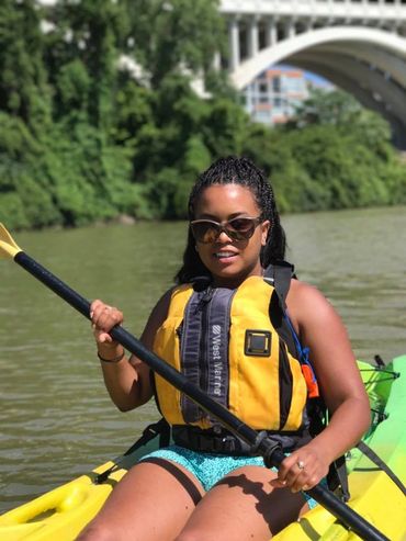African-American woman in a kayak on the Cuyahoga River.