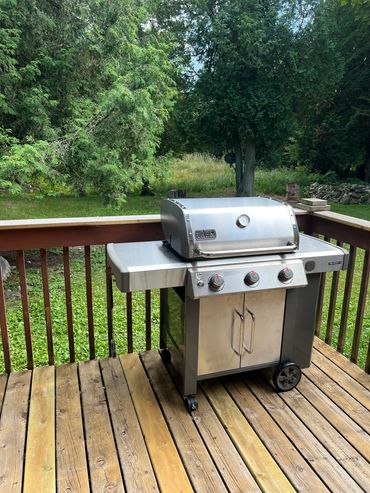 Grill on the patio with propane that is provided.