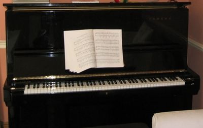 A black Yamaha upright piano