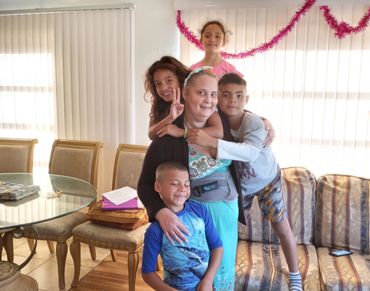 Parent from Cuba playing with her disabled children