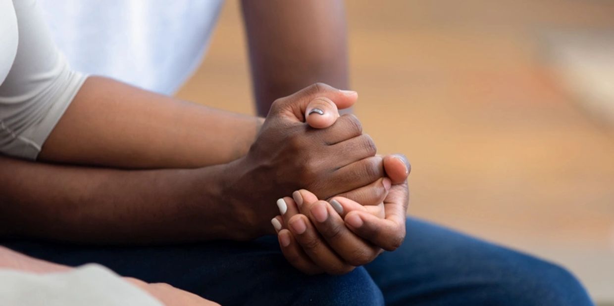This image of hands holding each other shows the way therapy can help people grow closer together.