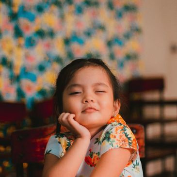 This child smiles with an attitude. MFTs provide parenting advice and guidance. MFTs also help kids.