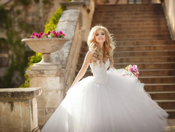 A naughty blonde bride, with cool make-up in a wedding dress.