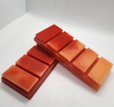 Two segmented reddish-brown wax bars on a white surface.