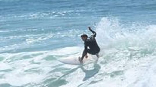 Surfer riding a wave on the ocean.