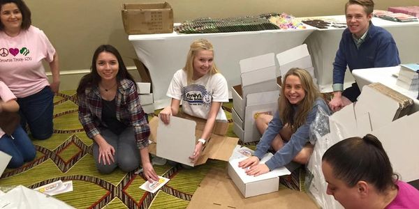 Volunteers making boxes full of toys and activities for children during hospital visits 