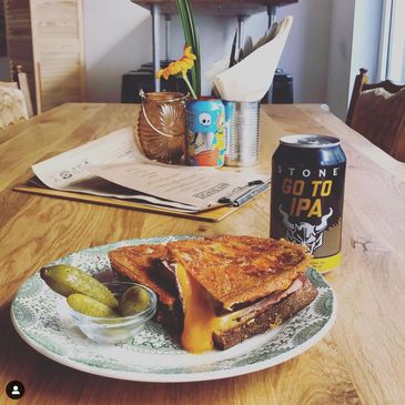 A grilled cheese sandwich with a can of Craft beer