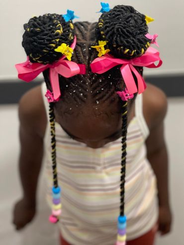 2 braided ponytails into buns .