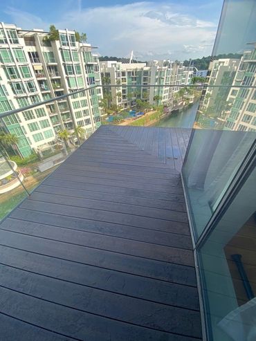 Balcony view overlooking modern apartment buildings and a water canal.