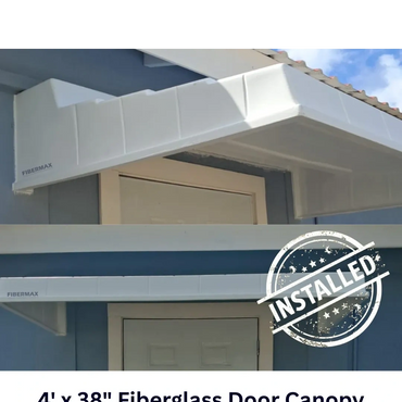 Installed white fiberglass door canopy above an exterior door.