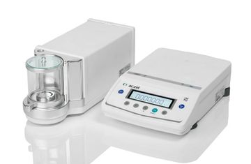 Digital laboratory balance with protective glass enclosure for precise weighing.