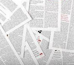 Scattered pages filled with dense text and occasional red highlights.