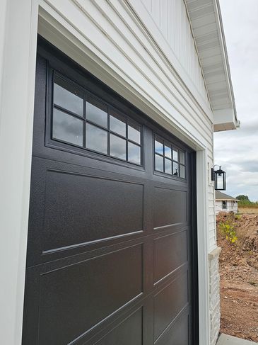 Newly installed black garage door