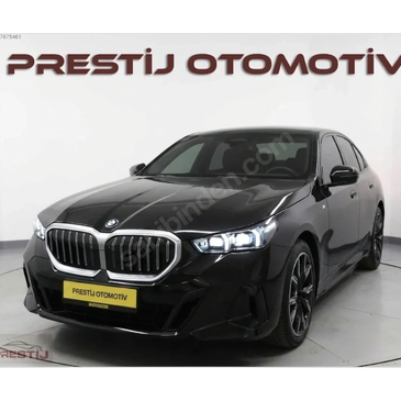 Black BMW sedan displayed in a showroom under Prestij Otomotiv branding.