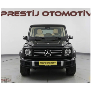 Front view of a black Mercedes-Benz G-Class SUV in a showroom.