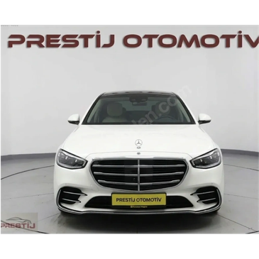 Front view of a white Mercedes-Benz car in a showroom.
